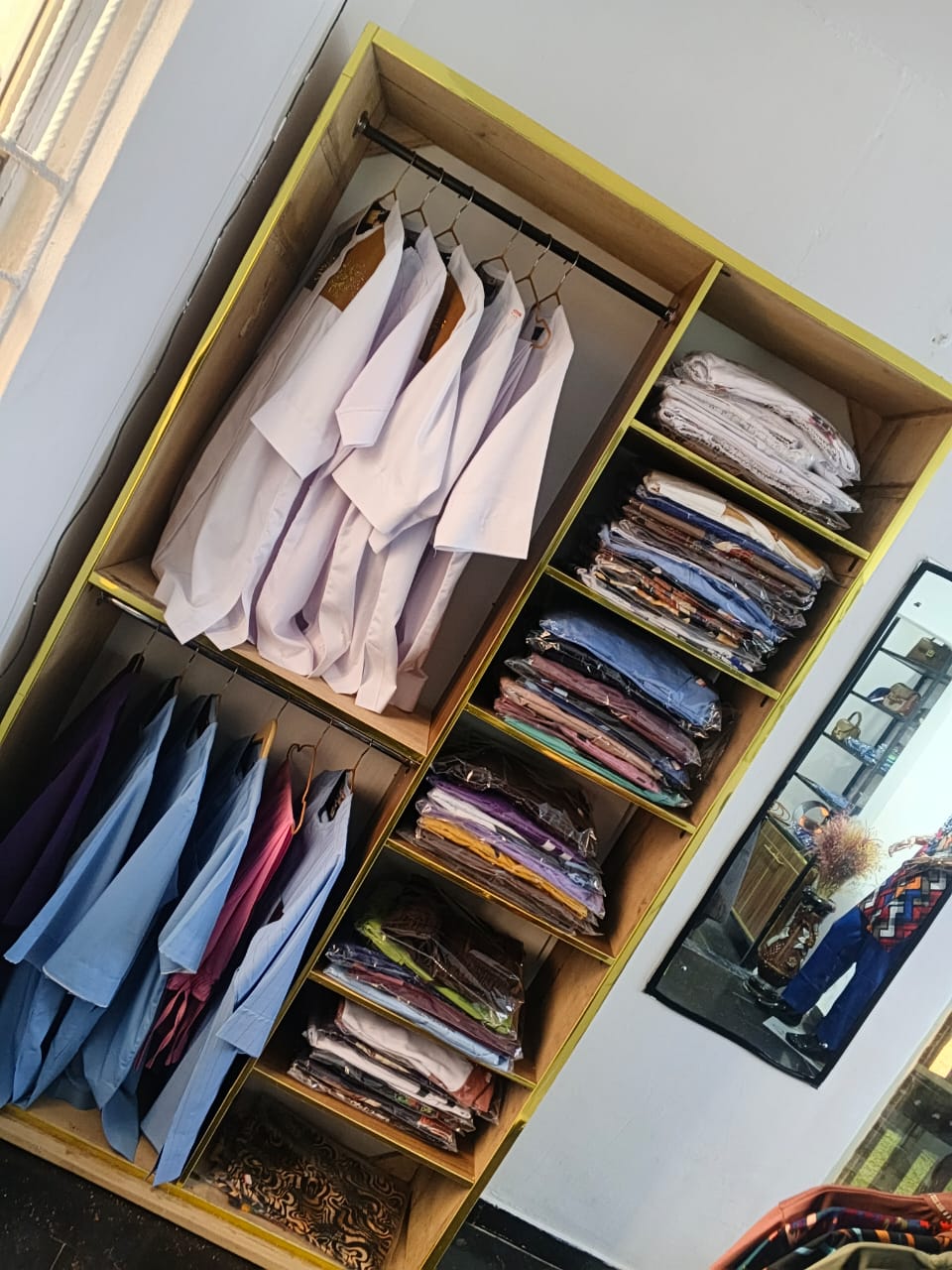 Inside Remmy's Prestige Fashion showroom — display rails and designs